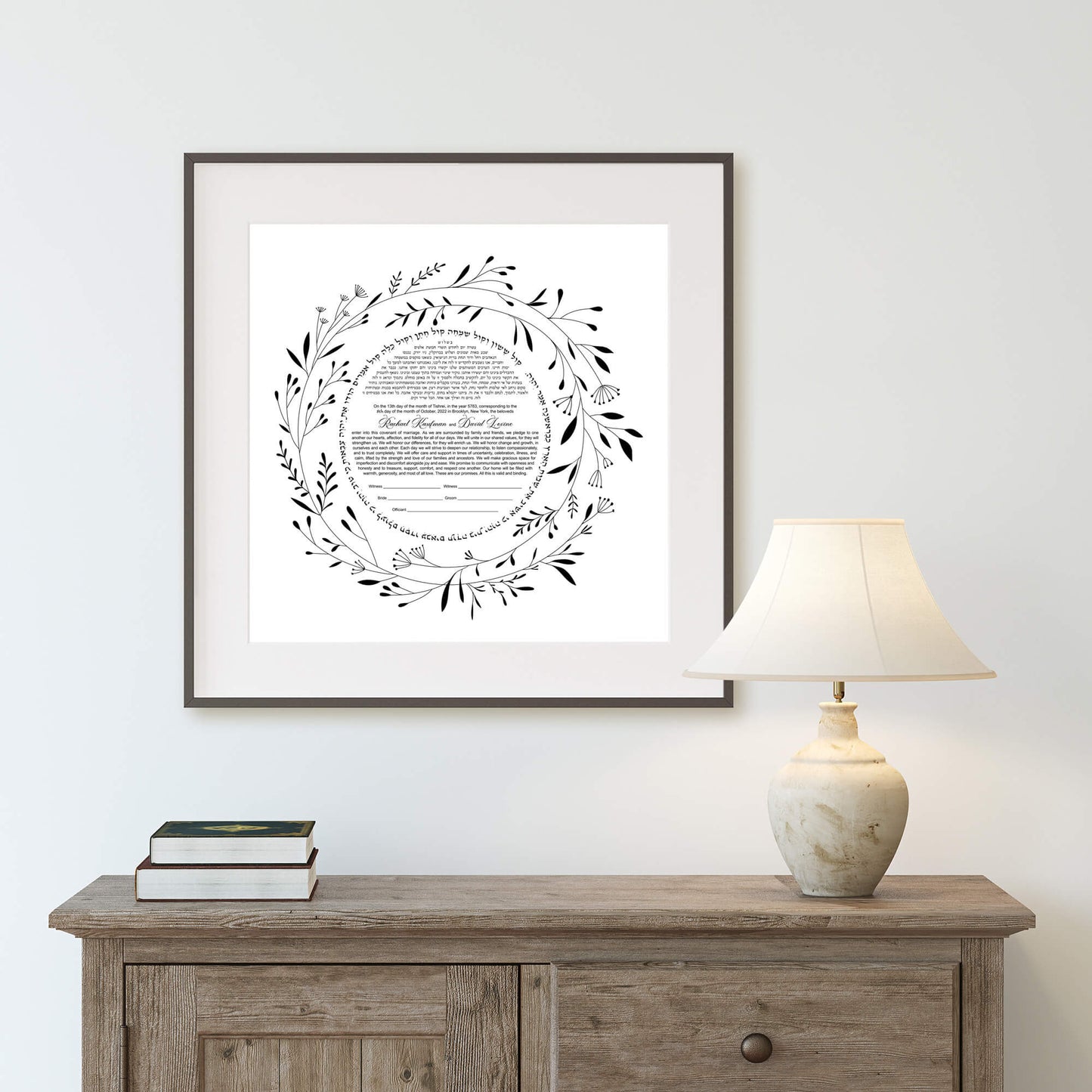 Minimalist floral ketubah displayed in a living room.