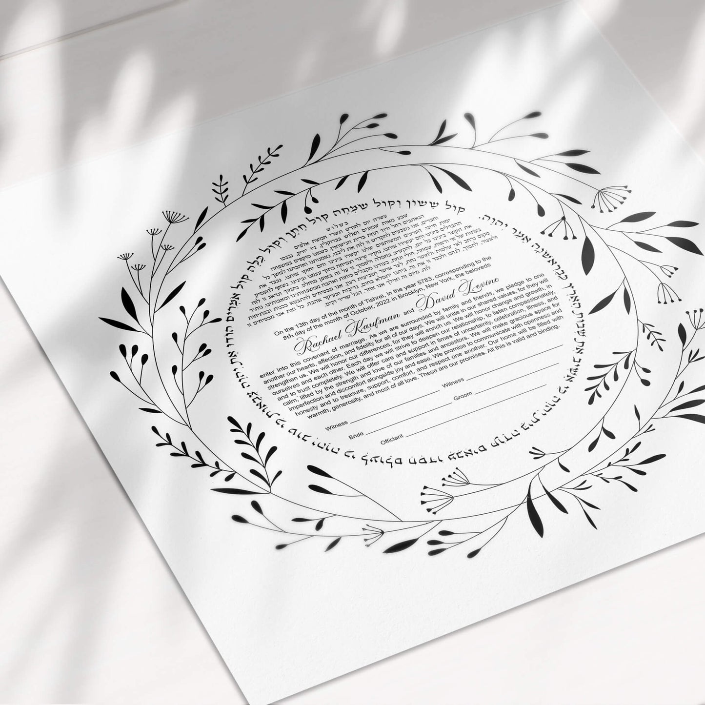 Minimalist black and white wreath ketubah on paper.