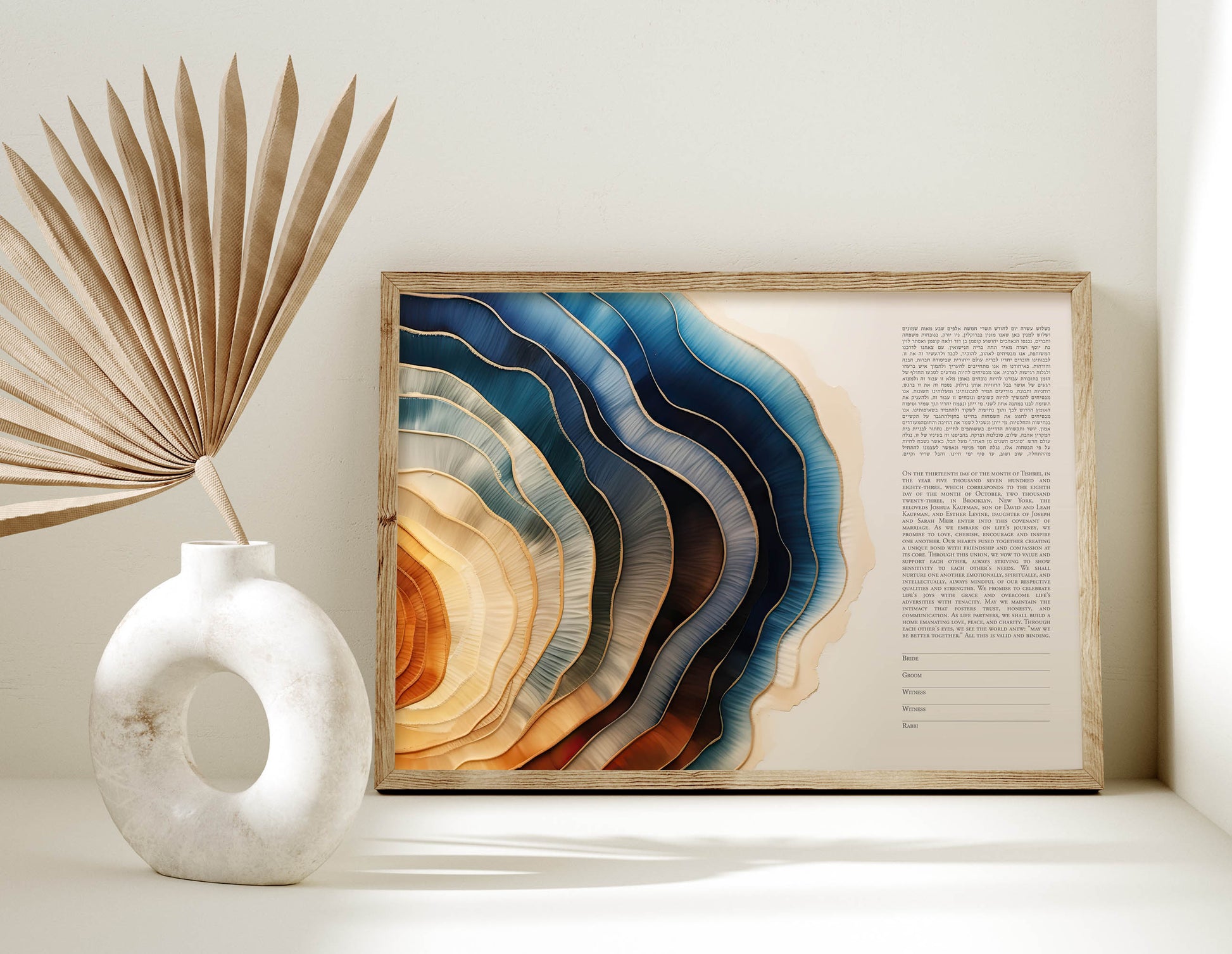 Framed abstract watercolor ketubah with a decorative vase and dried plant on a light background