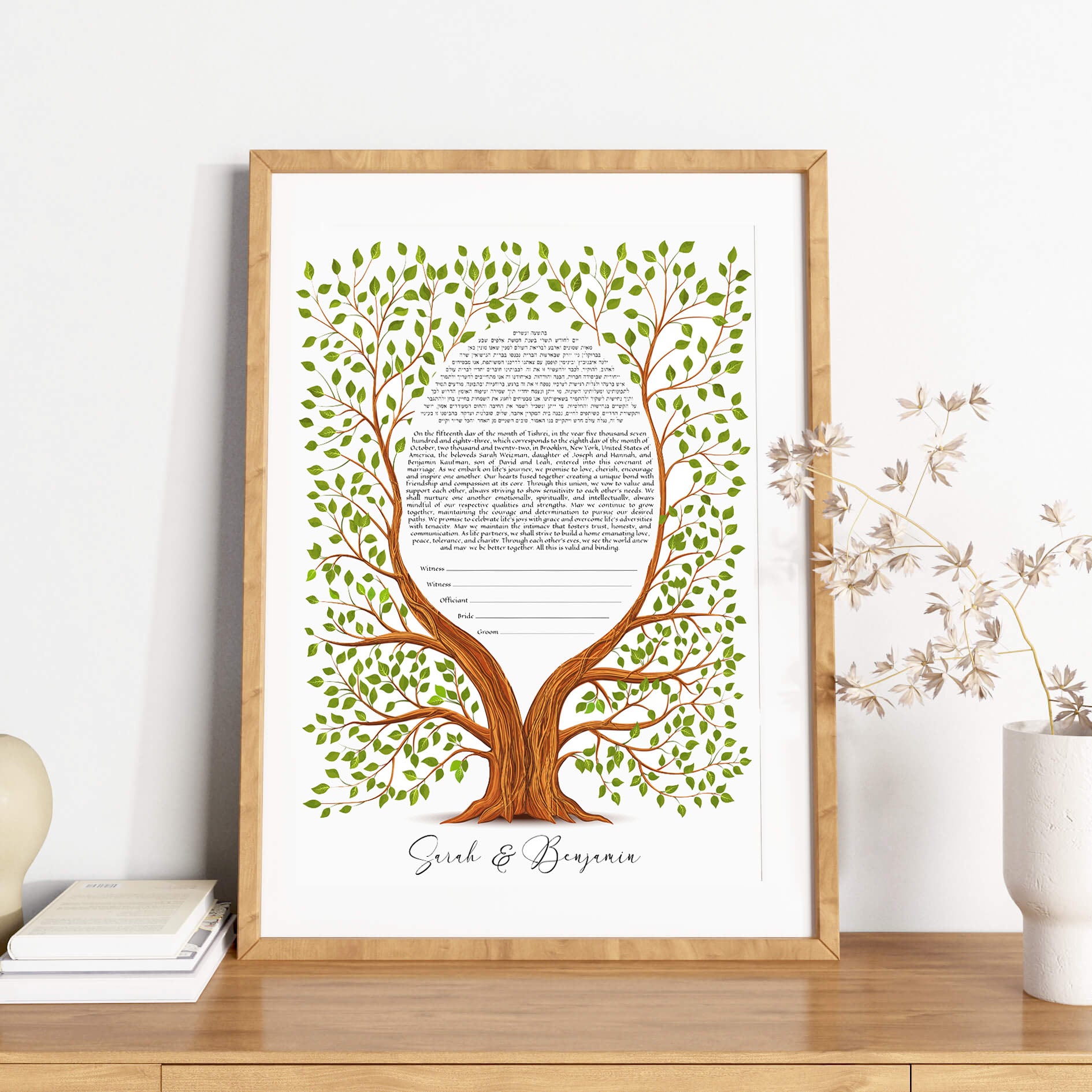 Tree of life ketubah in a wooden frame on a shelf.