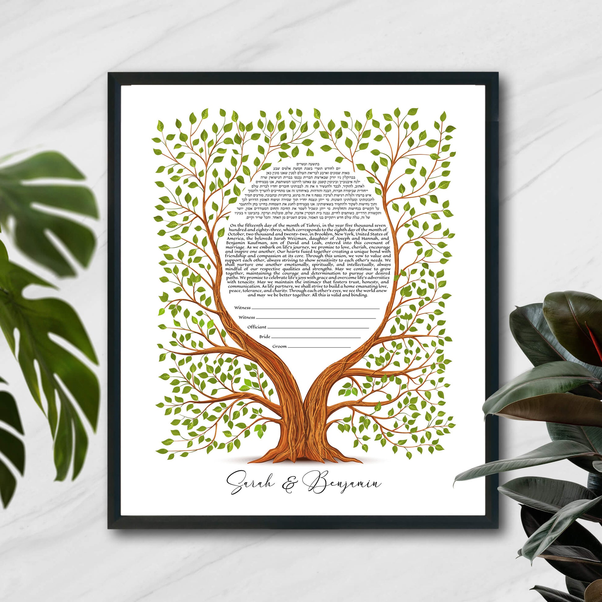 Tree of life ketubah in a black frame with plants.